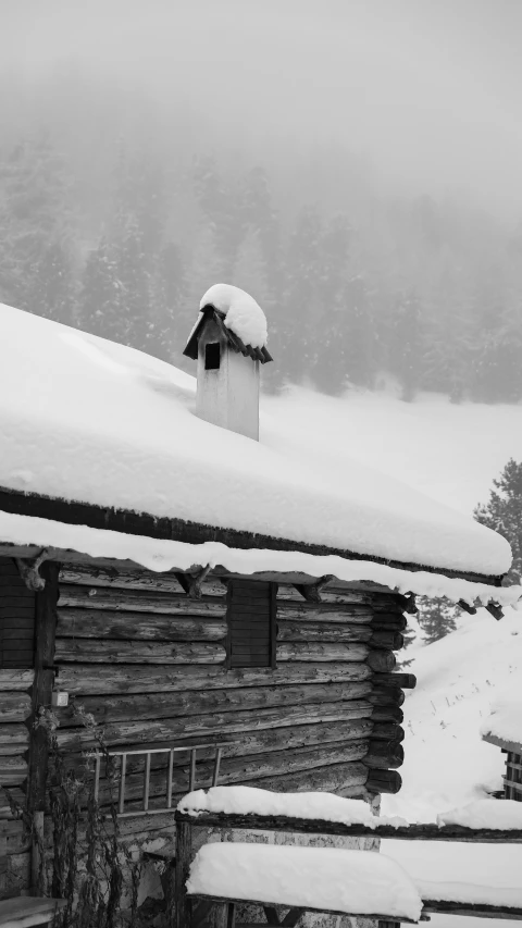 an old log house on a snowy mountain