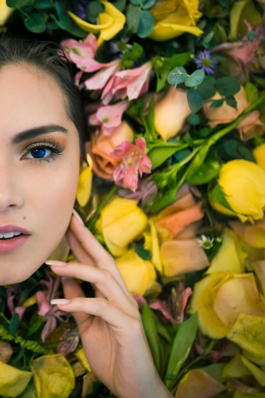 a woman laying down near flowers with a green and yellow background