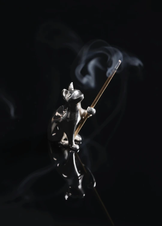a glass smoking holder with an animal on top of it