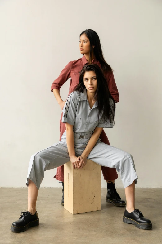 the young woman is sitting on the box posing with her 