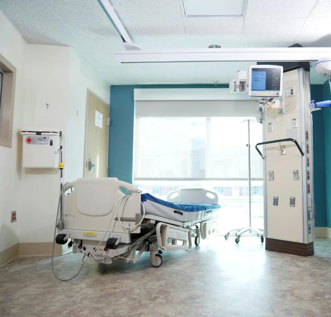 hospital room with a monitor and iv stand next to it