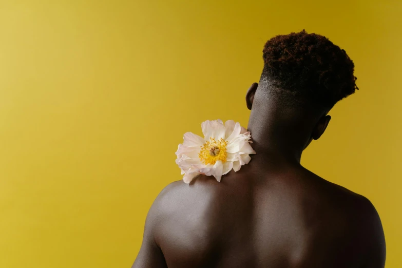 man with flowers on the back of his neck