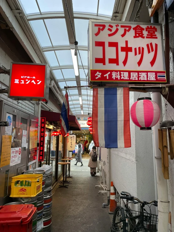 some signs are hanging from the ceiling in a shop