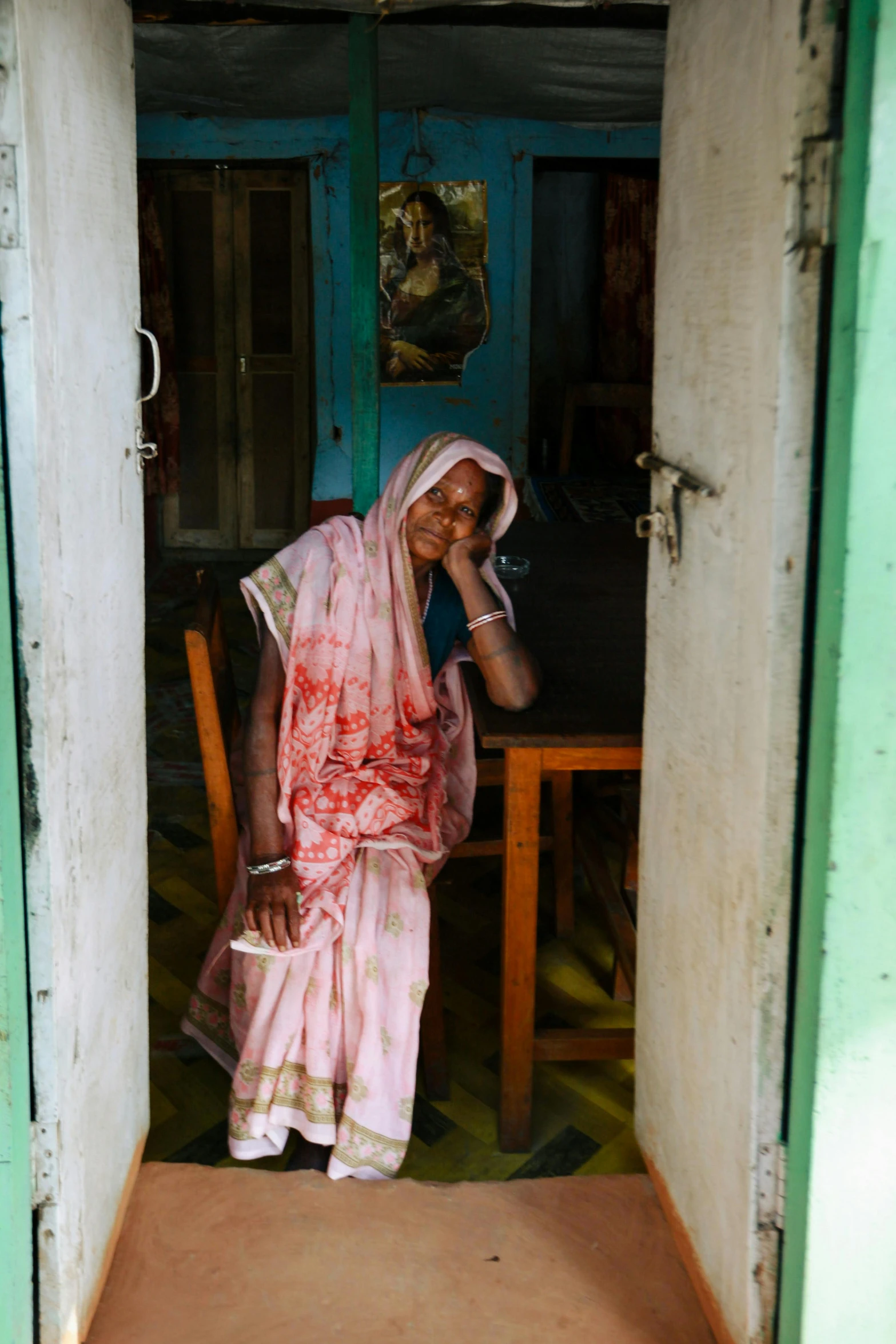 a person sitting down wearing a sari