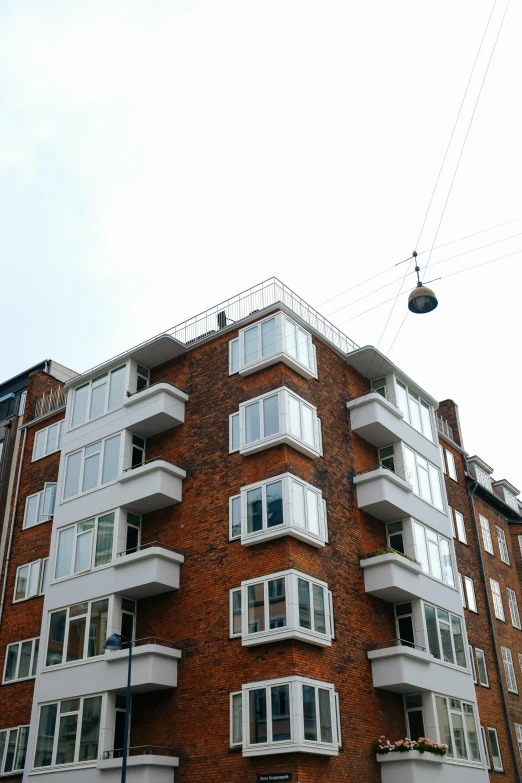 a multi story apartment building against a cloudy sky