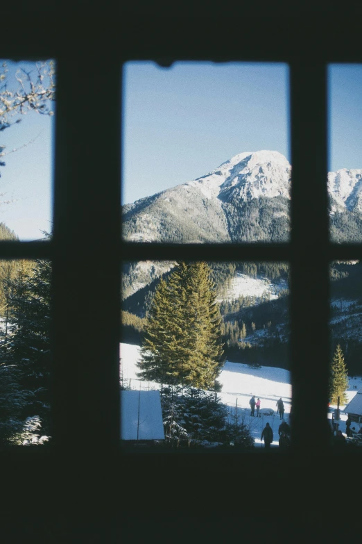 snow capped mountains seen through a window pane