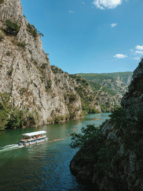 a boat traveling down a narrow body of water