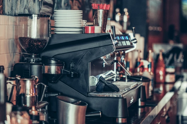 the espresso machine is on display with many coffee cups