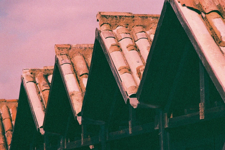 the tops of buildings with a few wind turbines on top