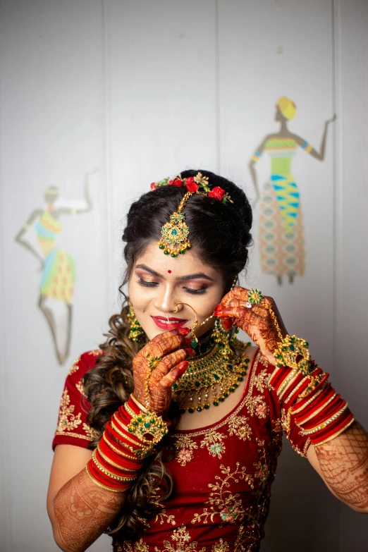 a woman is holding jewelry on her face