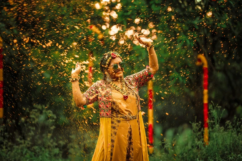 woman in yellow dress throwing petals of flowers