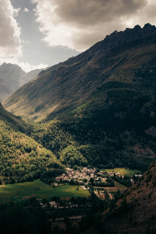 some large green mountains that have houses on them