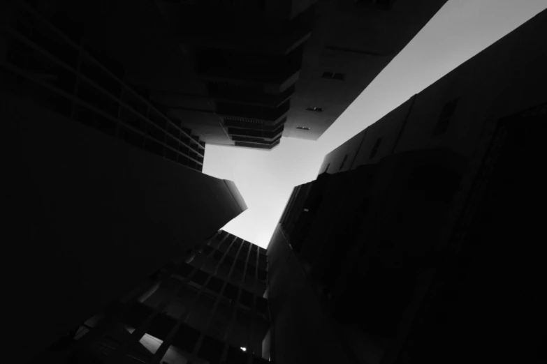 an upward view of an office building in black and white