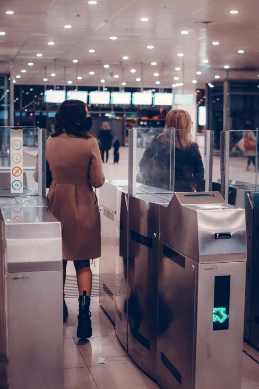 the woman is waiting for her flight at the airport