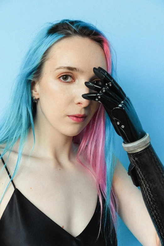 the woman with pink and blue hair is wearing a leather glove