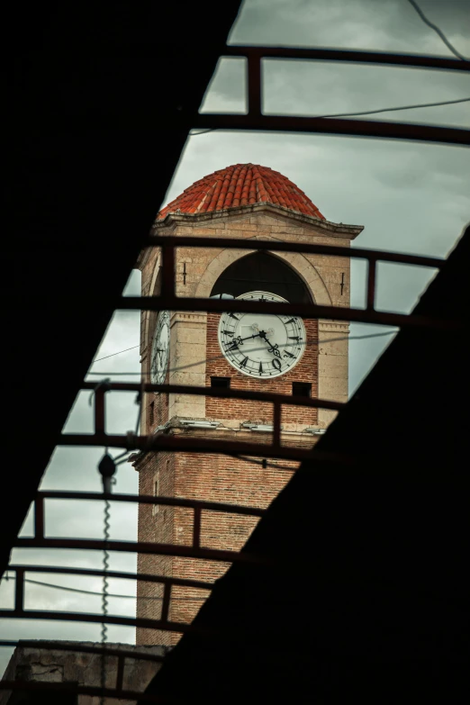 there is a clock tower that has a red roof on it