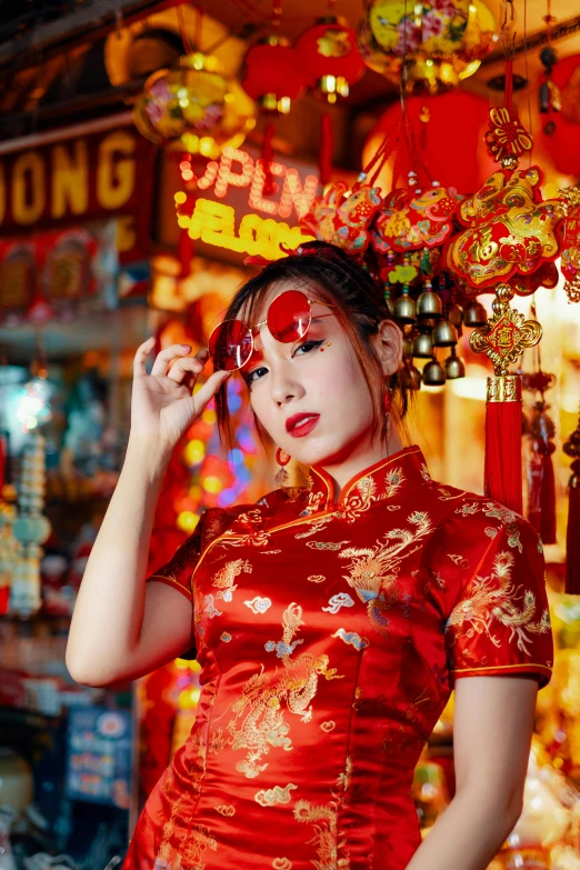 an asian woman in traditional red dress with red eye shadow