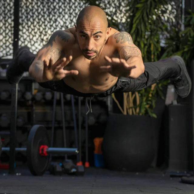 a man on the ground doing a trick with his hands