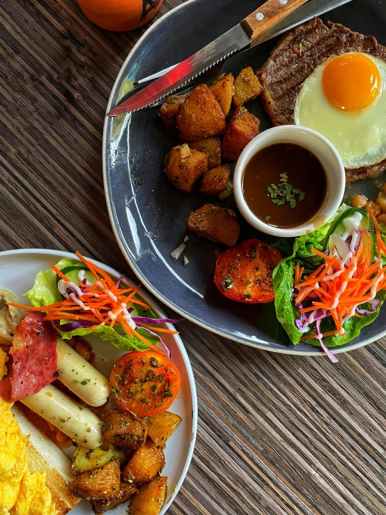 a plate full of food with eggs, a fork and a bowl of soup