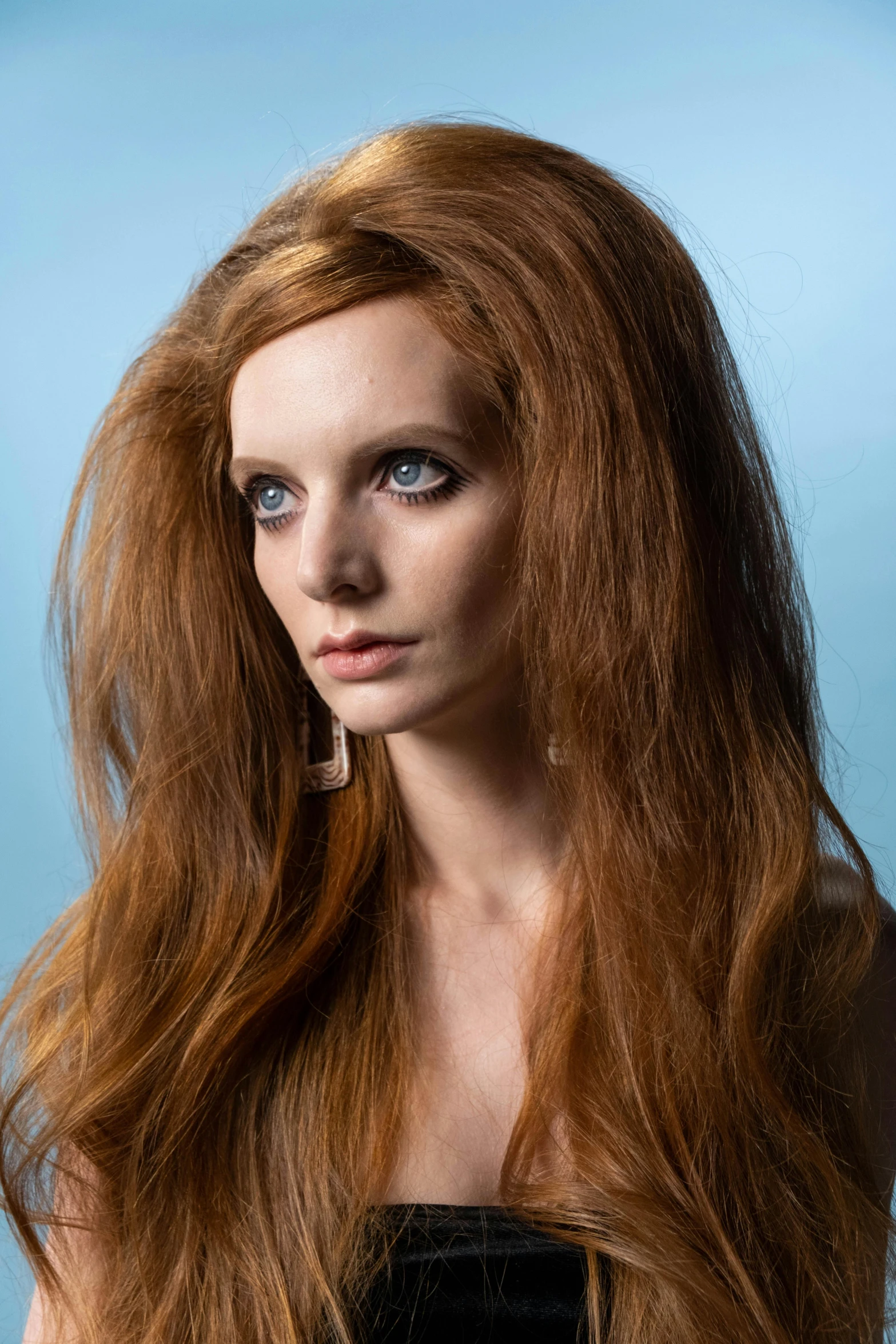 a close up of a woman with long red hair