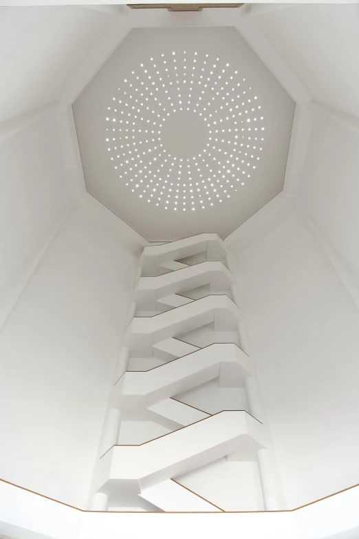 the ceiling inside a large building with white light from below