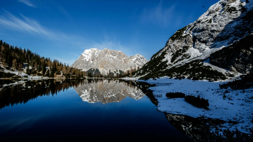 some mountains are reflected in the water