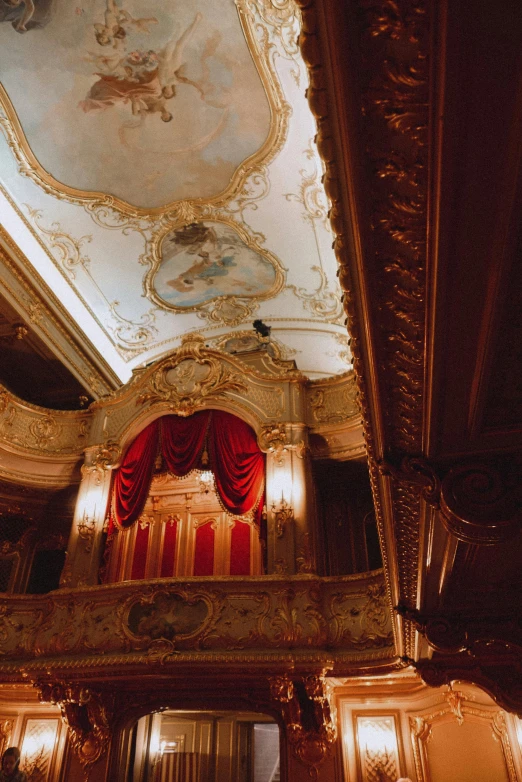 the ceiling in a building with red curtains