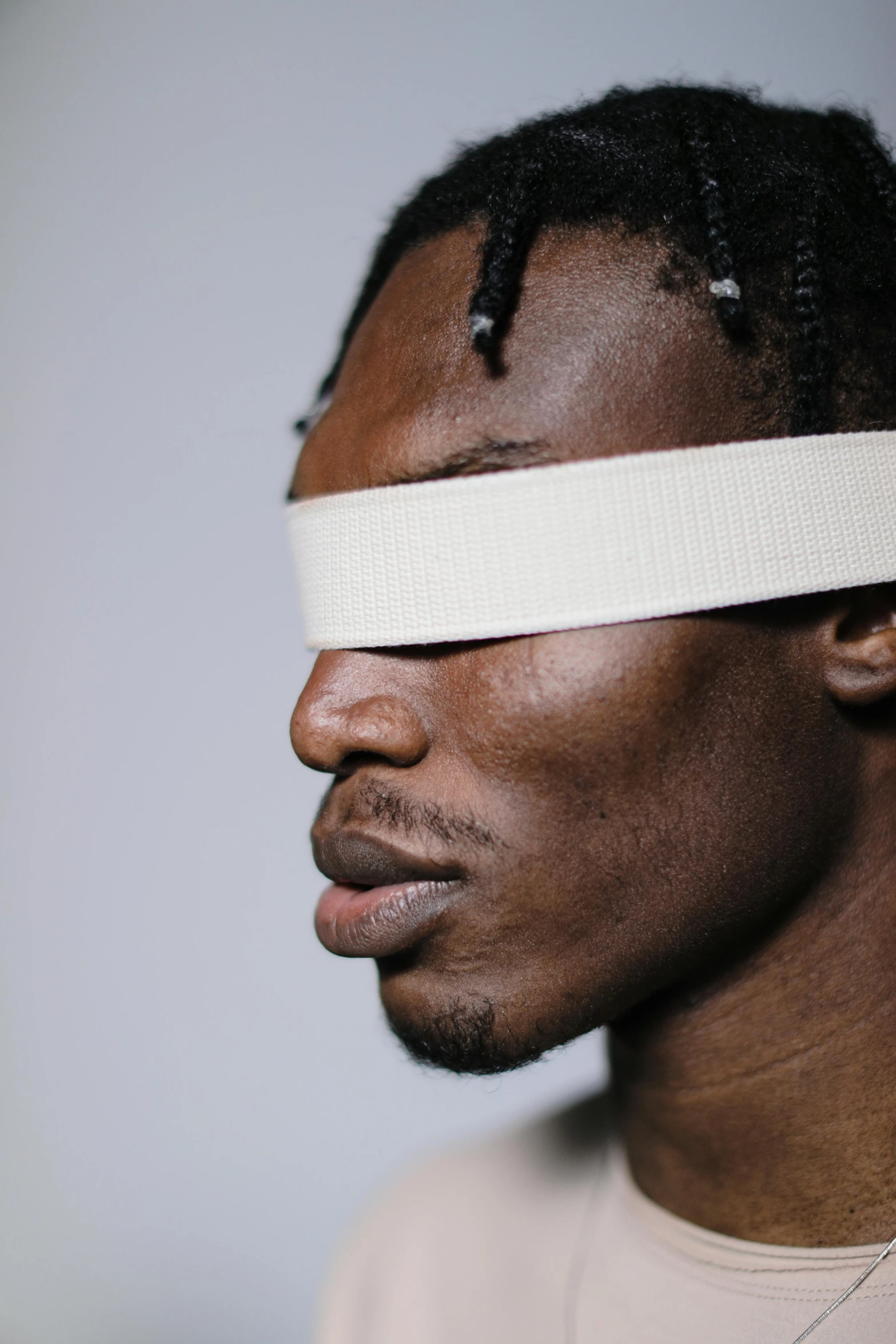 a black man with a tape wrapped around his face