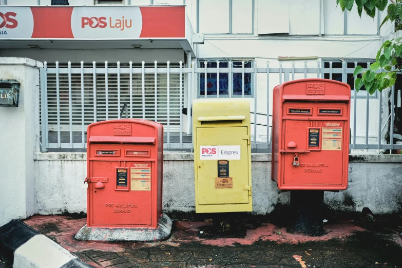 several post boxes are lined up on the street