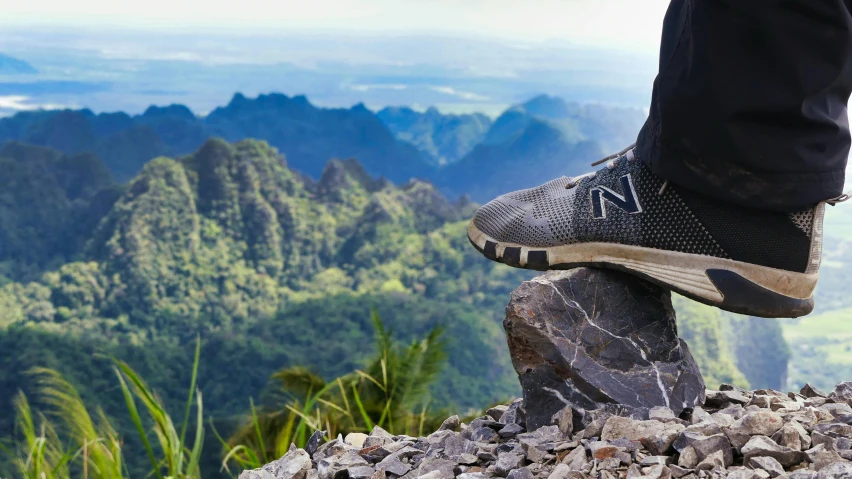 the foot on top of a pile of rocks