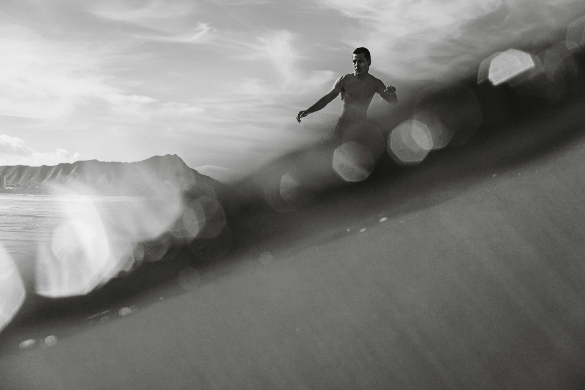 a person standing on top of a surfboard near the water