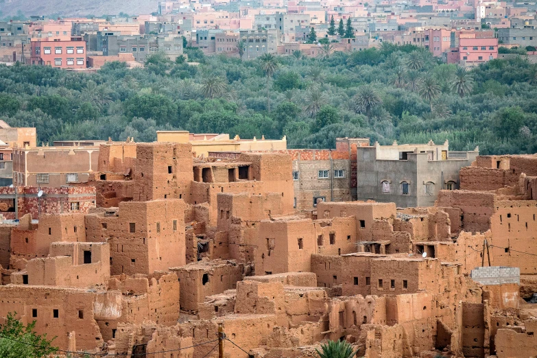 a village in an outback desert surrounded by green hills