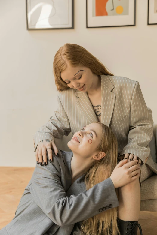 a woman is sitting on the lap of a man that has his arms around her neck