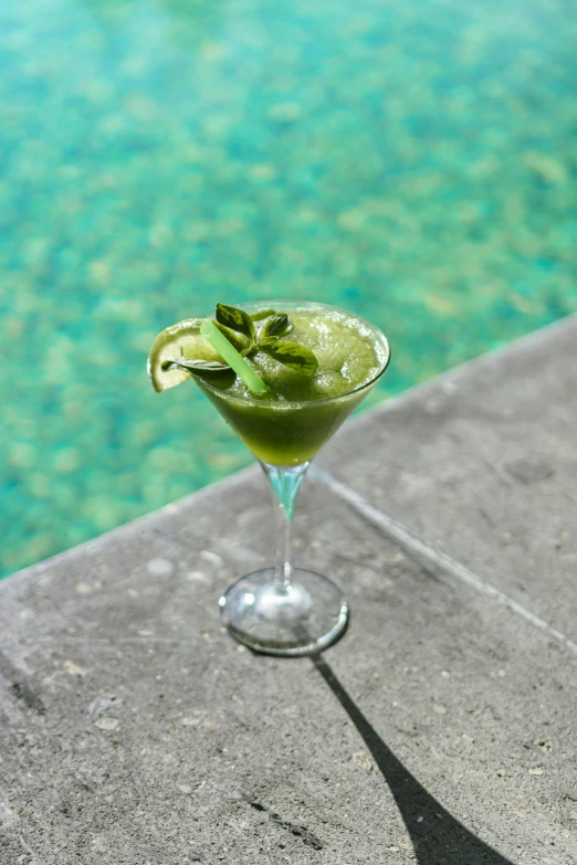 a margarita with an apple and lime wedge on the rim