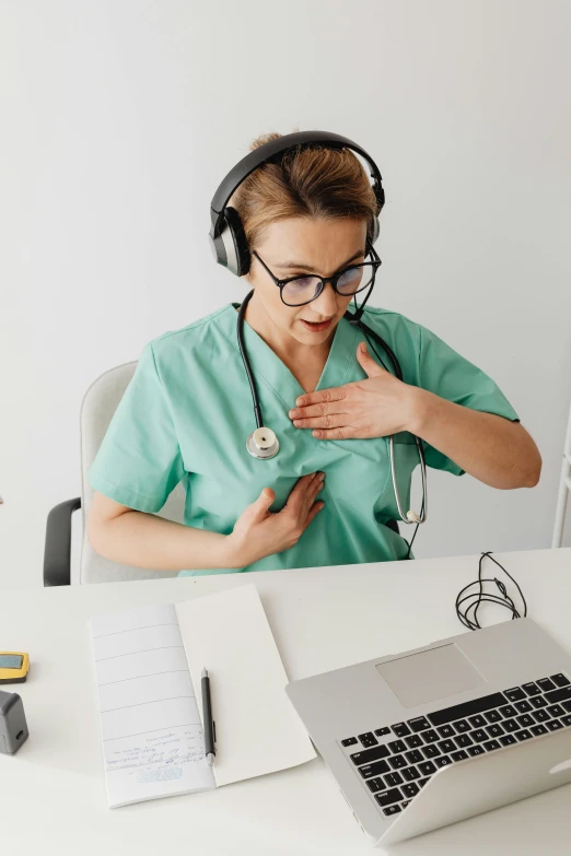 a doctor is on her phone with headphones over her face