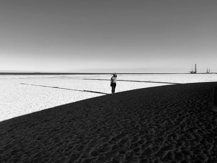 a man walks in the sand at a beach