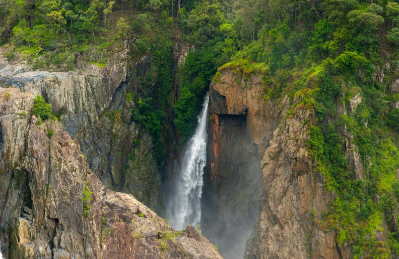 large waterfall running down a steep, steep, rocky hill