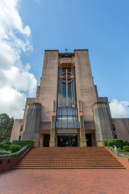 the front entrance to a church with a cross and staircase