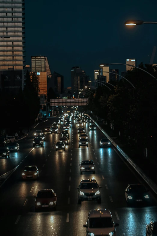 many cars driving down a city street at night