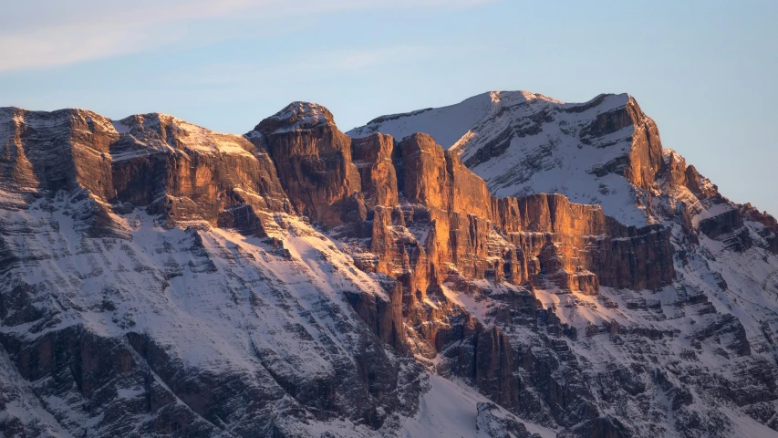 the mountains are covered in snow and have no clouds