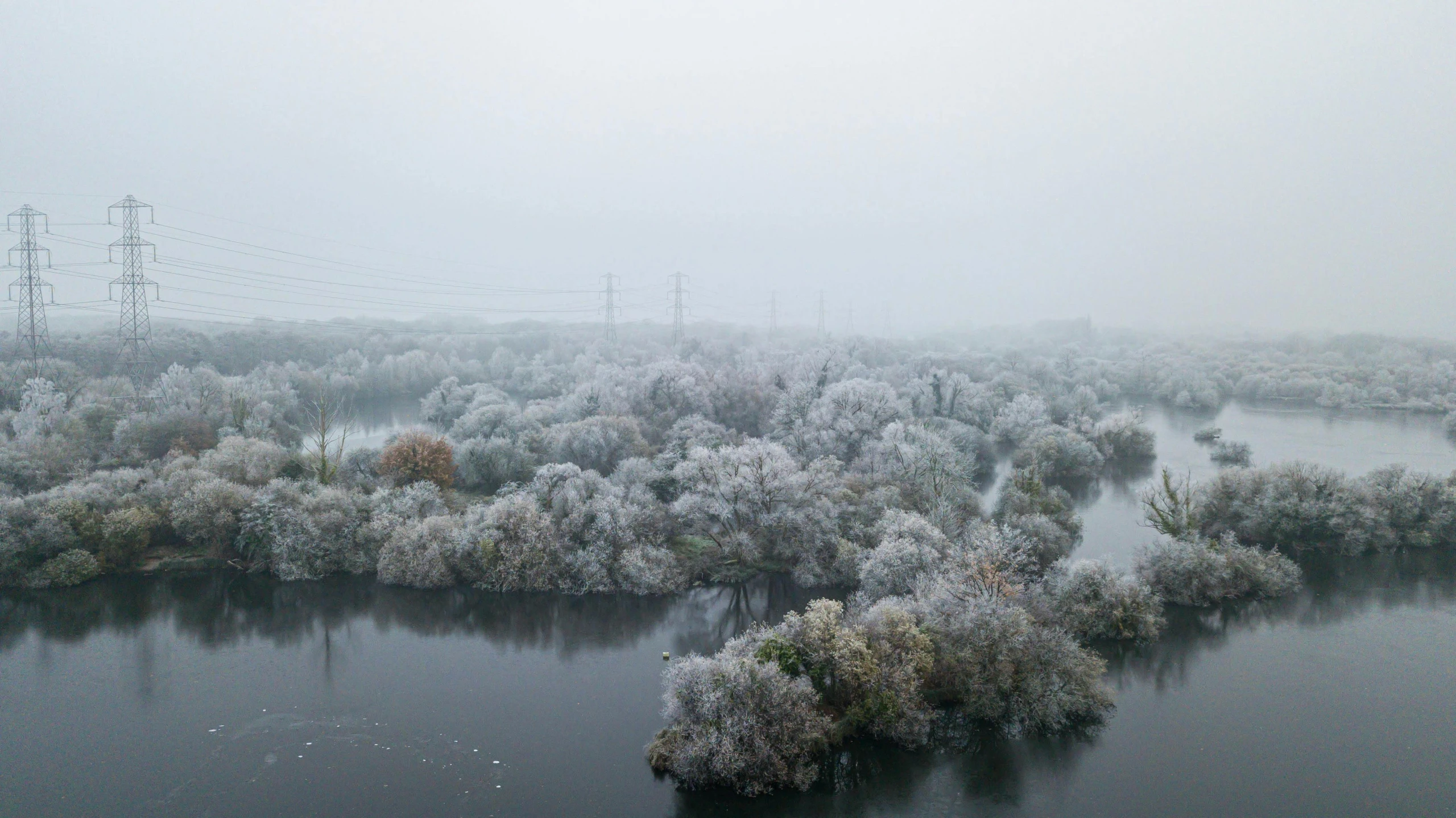 a flooded waterway is shown in frosty conditions