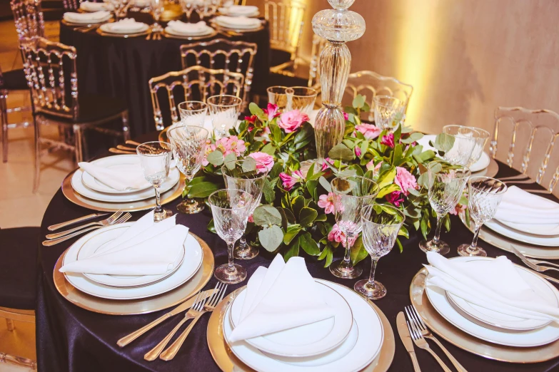 this is the table setting with rose and greenery on it