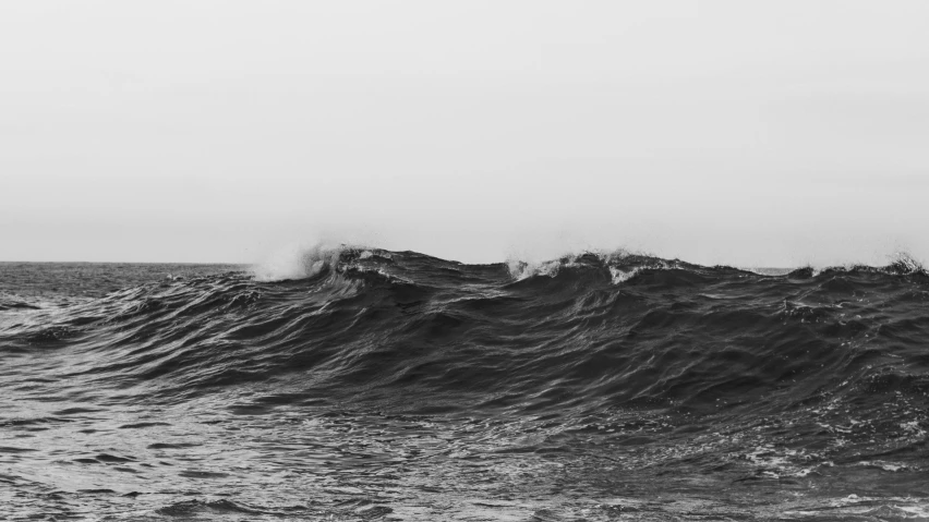 black and white pograph of an ocean with the waves