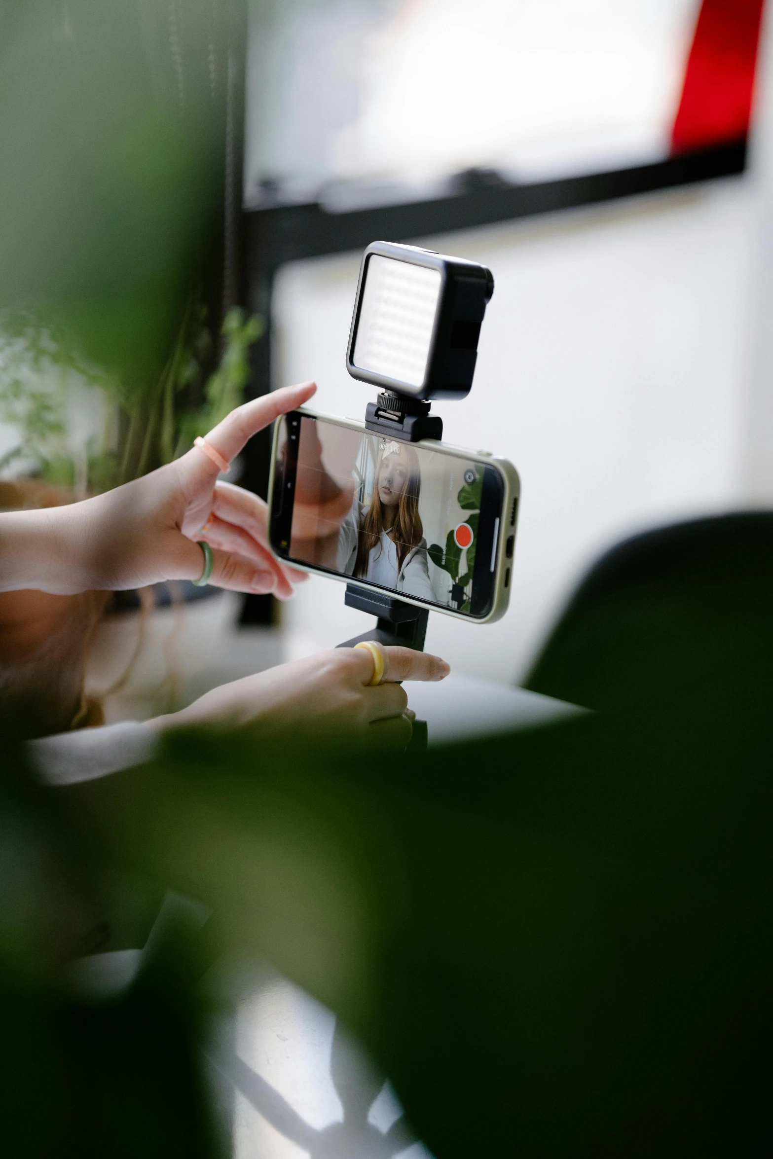 a girl holding her cell phone taking a picture