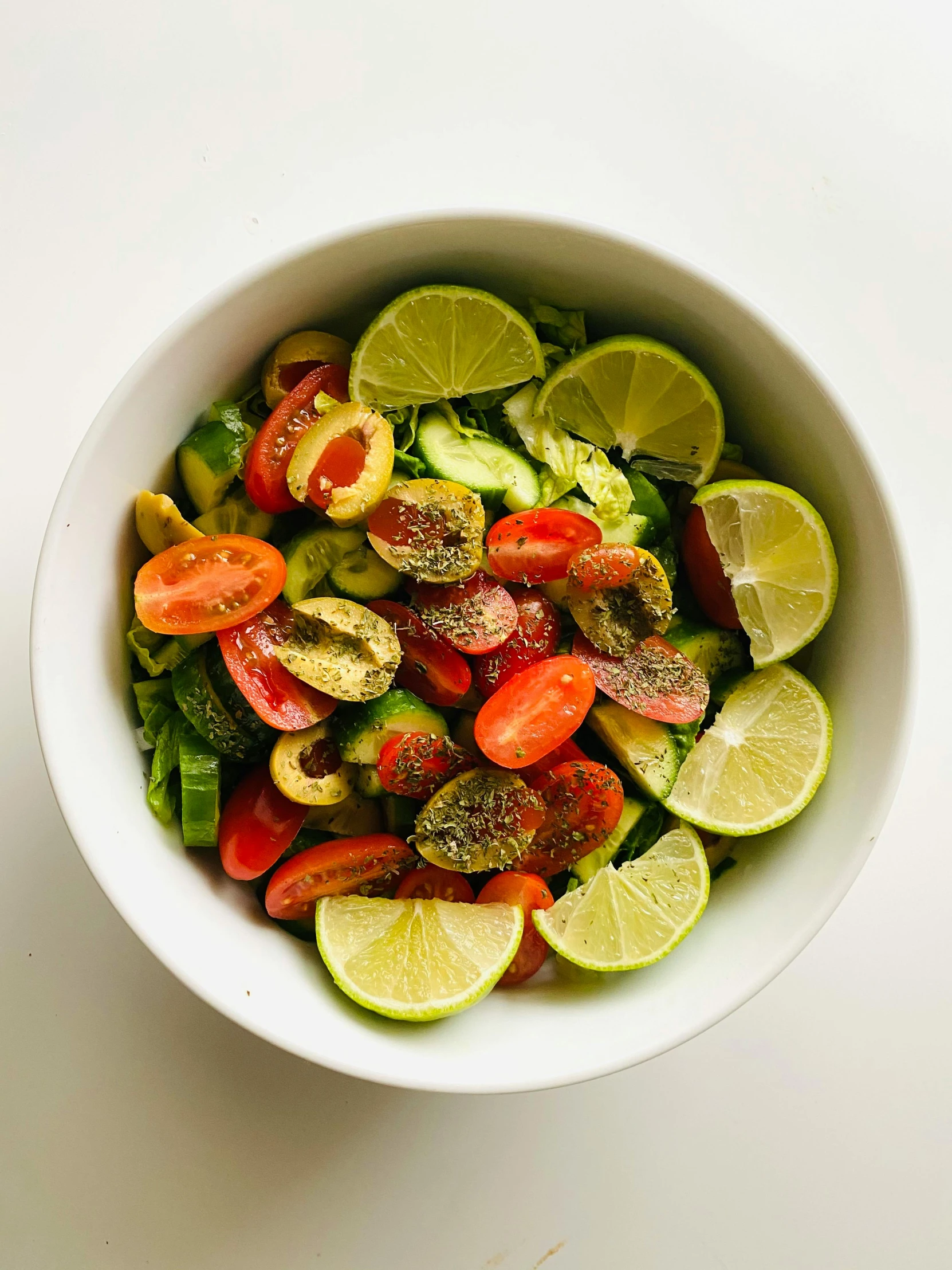 a bowl of sliced up vegetables sitting on a table