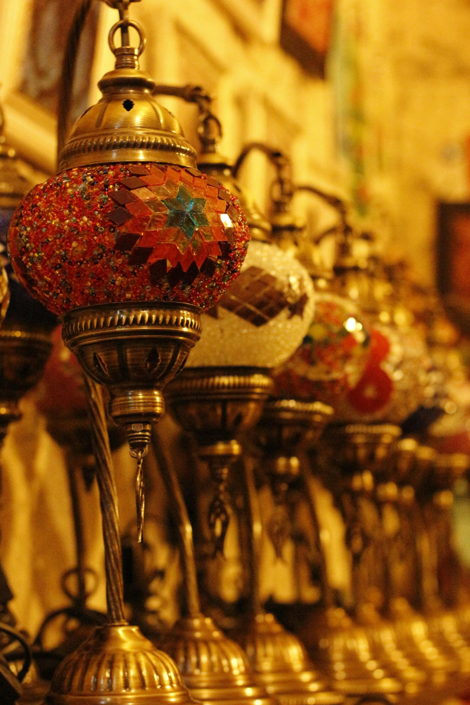 a variety of ornate lamps hang on the wall