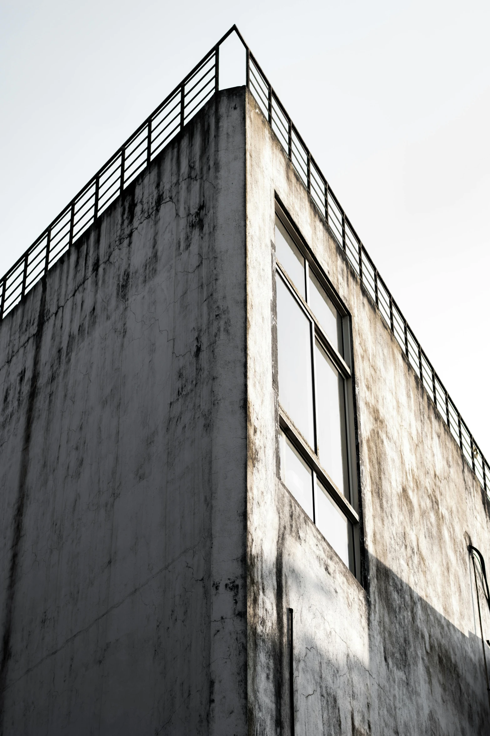 a dark building is shown with the sky above