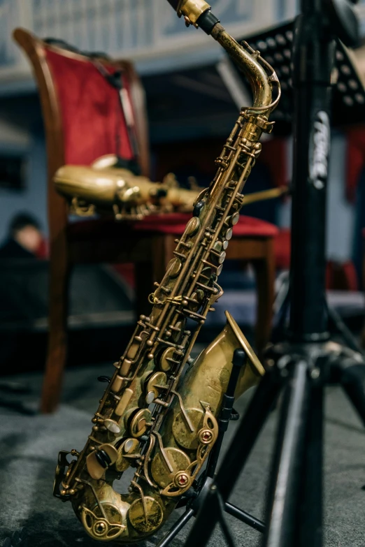 a close up of a saxophone on a stand