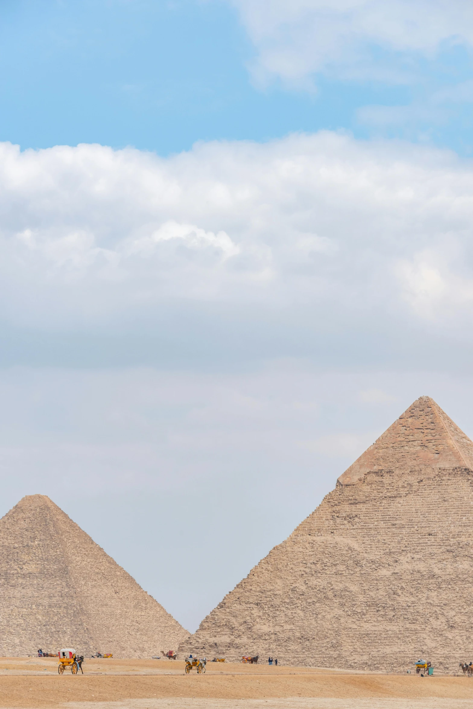 a picture of three pyramids that are in the desert