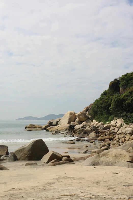 there are lots of boulders and a body of water